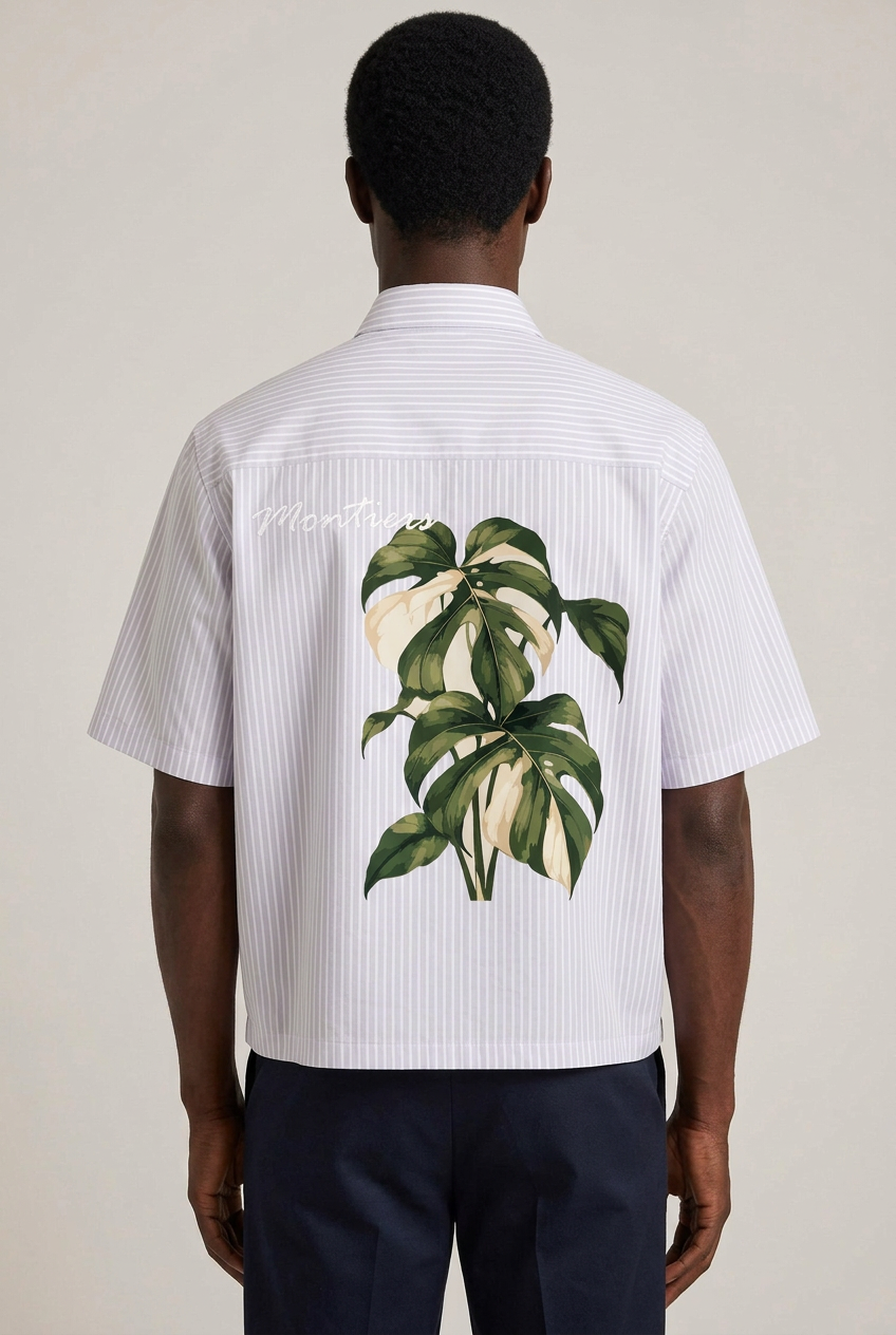 Back view of the African model wearing the Monstera Breeze shirt